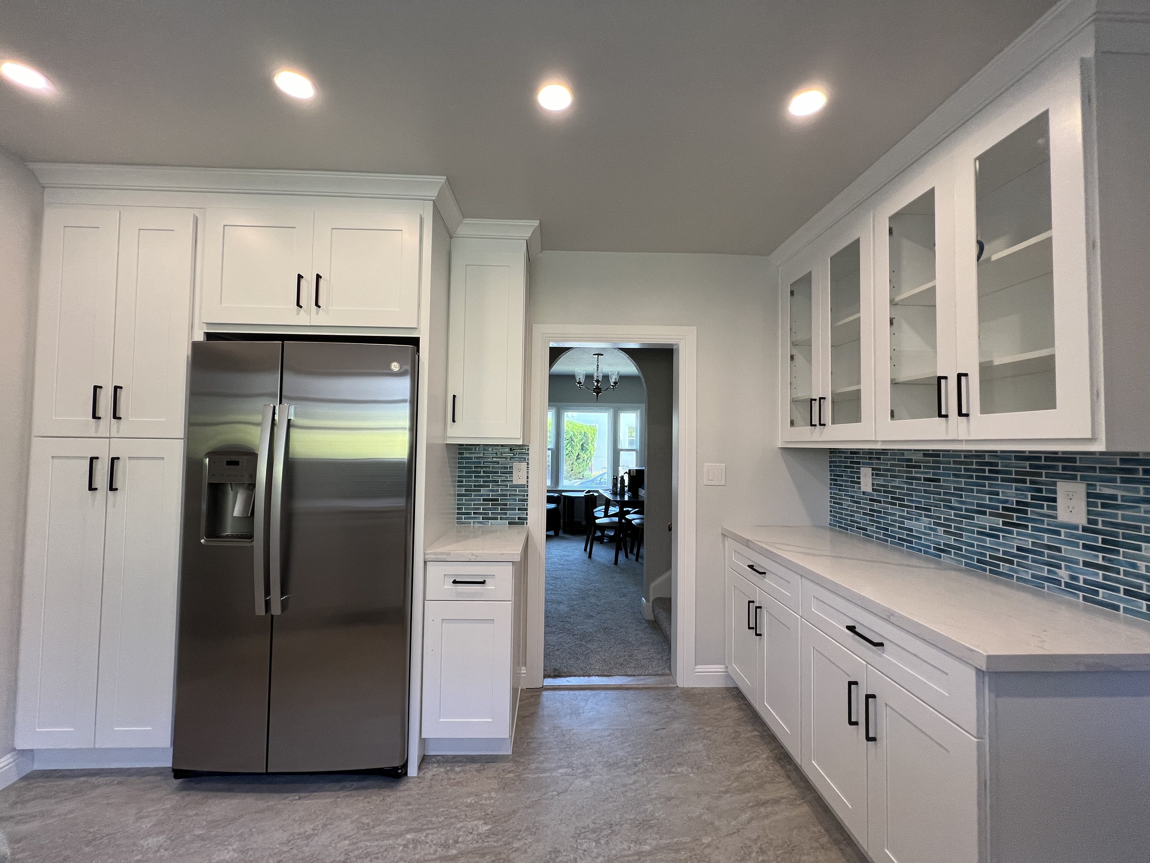 Bright Shaker Kitchen with Blue Glass Tile Backsplash
